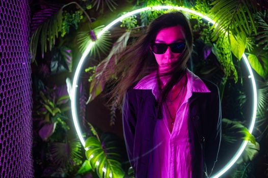 Portrait of asian man wearing sunglasses in neon light