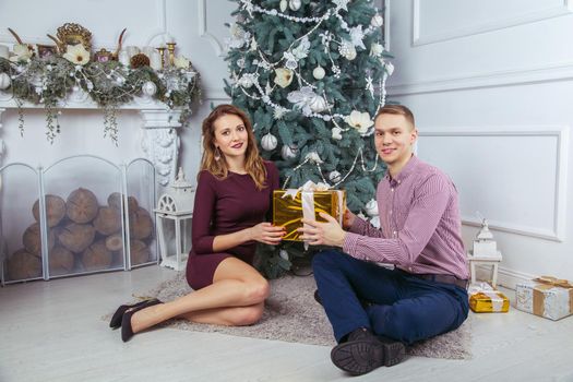 Young beautiful love couple celebrating new year. Woman and man celebrating Christmas