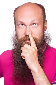 Portrait of a young blad bearded man with his finger in his nose, isolated on white background..