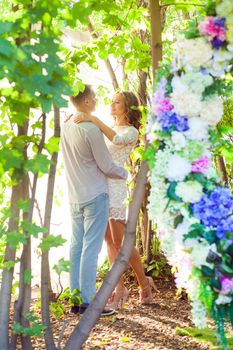 Full-length photo of handsome beautiful couple walking spring garden. Outdoor shot, spring park or summer concept. Love, sensual people