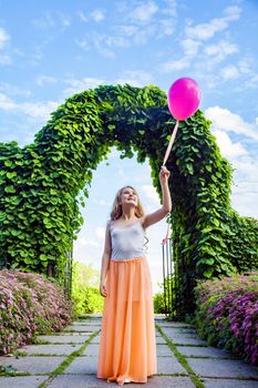 Portrait of happy girl with air balloon enjoying in the park on summertime.