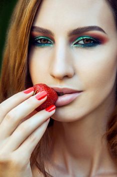Sexy Woman Eating Strawberry. Sensual Red Lips. Red Manicure and Natural Lipstick. Desire. Sexy Emotion with Strawberry.