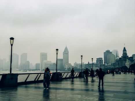 The Bund Shanghai China,2018 People walked on promenade to take beautiful cityscape of Shanghai from The Bund 's side in the rains.