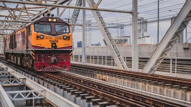 Bangkok Thailand ,Augest 2019 Old vintage train in Thailand riding on iron bridge across river in Bangkok.