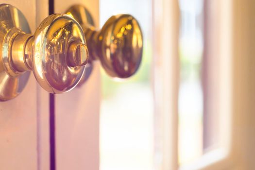 close up of metal handle on a old wooden door,golden door knob. close up of metal handle on a old wooden door,golden door knob.