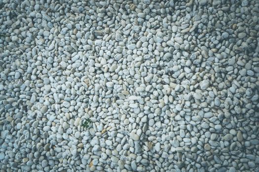 White pebble stone texture on the ground abstract background graphic