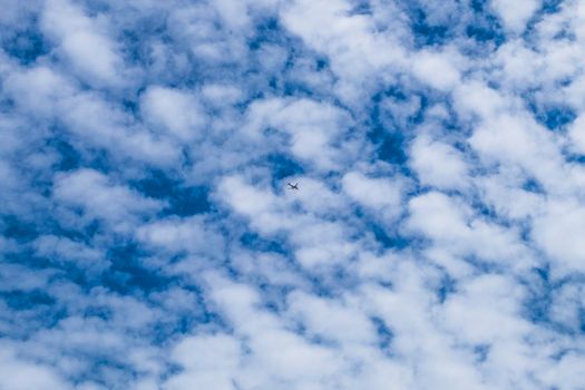 small Airplane flying in the blue sky among white clouds and sunlight . Airplane destination background. Adventure time concept . lost and found concept idea