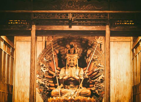 Golden Wood Statue of Guan Yin with thousand hands . Golden sculpture of Avalokiteshvara Buddha or Guanyin with thousand hands in Bangkok ยี่) Dragon Temple Kammalawat  Thailand