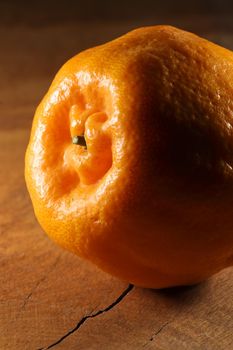 Fresh satsuma mandarin tangerine (Citrus unshiu) citrus fruit on natural wood surface close-up, South Africa