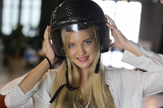 Portrait of smiling woman with helmet.