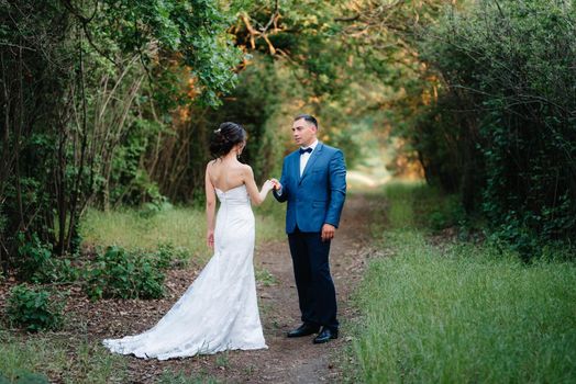 A couple in love a guy and a girl on a walk in the forest belt