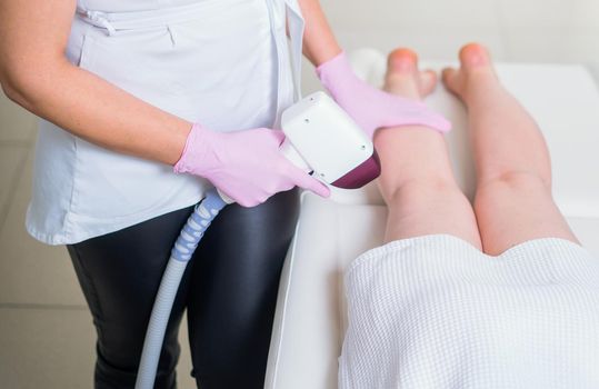 woman in professional beauty clinic during laser hair removal