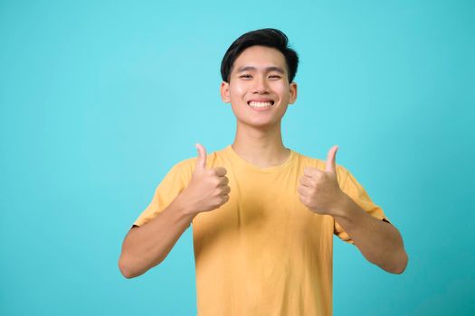 Young man looking confident with smile on face, pointing oneself with fingers proud and happy.