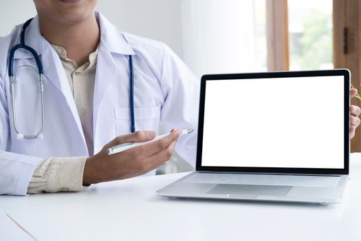 Doctor using computer discussion something with patient. Health care , Hospital and Doctor concept. Copy space of blank computer and tablet screen.