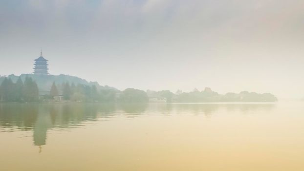 The beautiful scenery of Hangzhou, West Lake and pagoda  china.travel destination in Asia. morning scenatic foggy over lake .