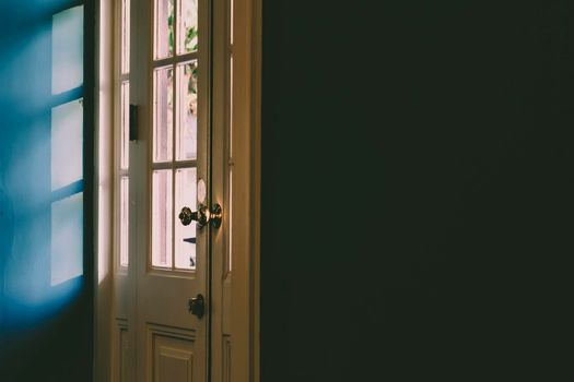 Light and shadow abstract.Sun shaded white wooden door frame and panel. Late afternoon sunlight provides lines and shade.