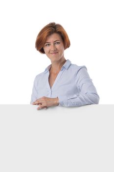 Beautiful redhead business woman holding blank sign isolated on white background