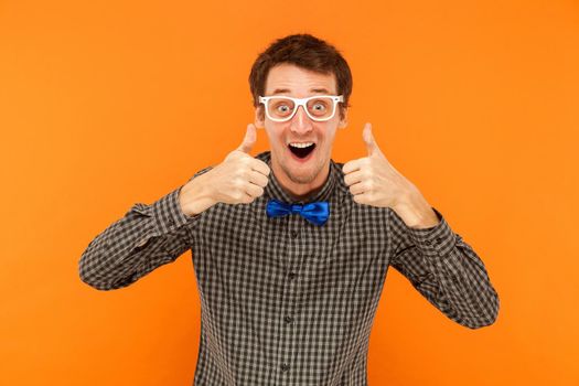 Crazy manager thumbs up. Studio shot. Isolated on orange background