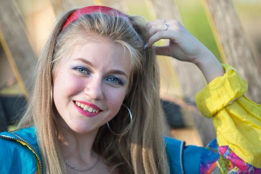 Beautiful country girl in 90s style with bright makeup and sports trowel.