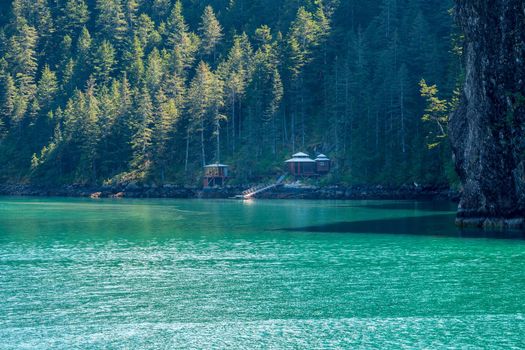 Small modern wooden cabins on the shore of Resurrection Bay near Seward Alaska
