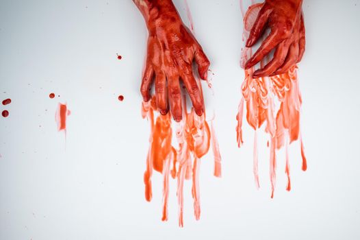 Female hands in blood on a white background