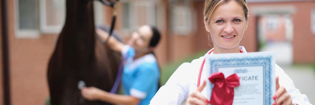 Veterinarian shows the certificate of the horse, close-up, blurry. Expert opinion of a veterinarian. Horse breeding, sports