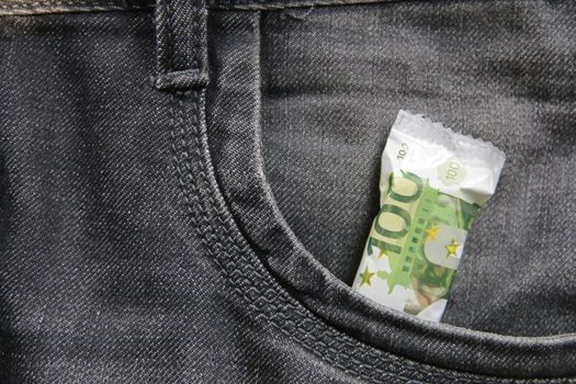 Money in pocket creative idea. idea. Candy in a jeans pocket. High quality photo