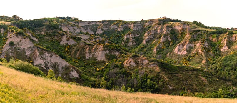 Eroded hills in Montespino, near Pesaro and Urbino in Italy, at evening before the sunset