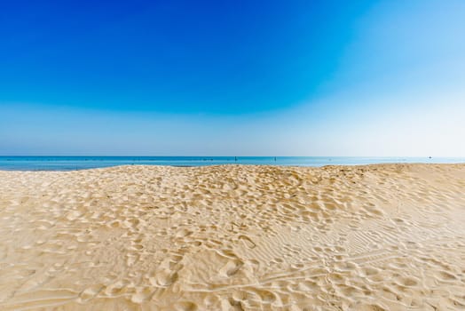 View of the Adriatic Sea from the sandy beach in Pesaro, Italy, during a sunny spring day