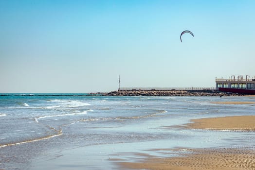 Kite surfing in Pesaro, Marche region of Italy, on the Adriatic sea during a sunny and windy summer day