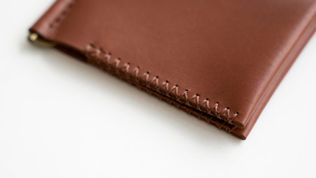 Empty classics brown leather handmade money clip wallet on white background. Leather accessories