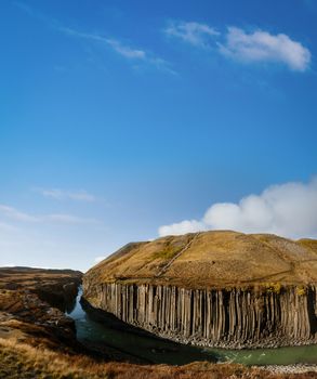 Fjadrargljufur basaltic canyon panorama with iron viewpoint under the blue sky