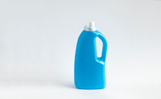 Blue plastic bottle stands on white background. Conditioner or liquid powder for washing. Capacity with space for copying. Layout for logo application