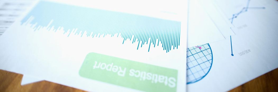 A statistical report with a diagram lies on the table, close-up, blurry. Monitoring of the assessment of indicators, annual reporting