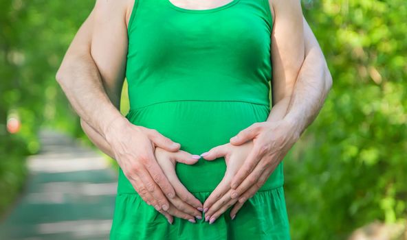 Pregnant woman belly and man. Selective focus. nature.