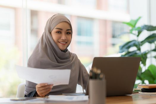 A portrait of Asian happy Businesswoman smiling and working at office