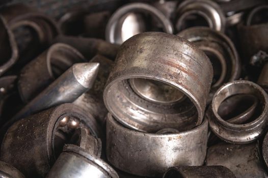 Old clips from automotive bearings. Metal scrap in shallow depth of field. Metal waste.
