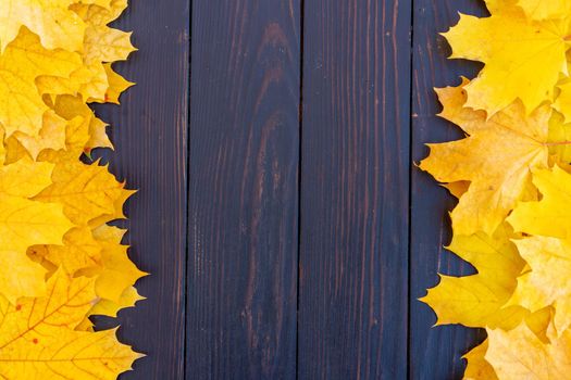 Autumn leaves frame on two left and right side wooden background top view Fall Border yellow and Orange Leaves vintage wood table Copy space. Mock up for your design. Display for product or text