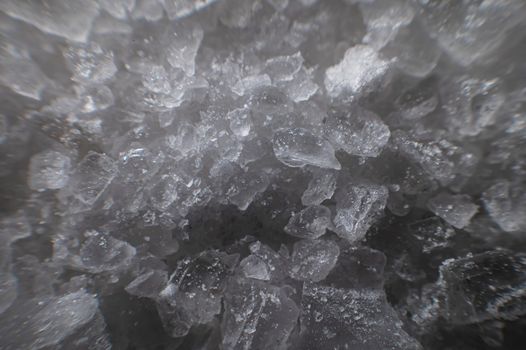 Close-up of crystals of dark sea iodized salt. Extreme macro background minerals salt.
