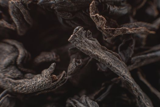 Dry black tea leaves close up. Macro background of tea production.