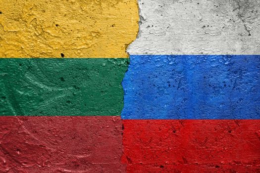 Lithuania and Russia - Cracked concrete wall painted with a Lithuanian flag on the left and a Russian flag on the right