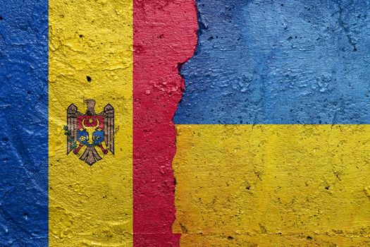 Moldova and Ukraine - Cracked concrete wall painted with a Moldovan flag on the left and a Ukrainian flag on the right