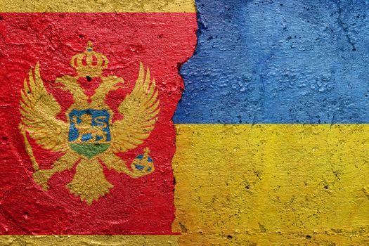 Montenegro and Ukraine - Cracked concrete wall painted with a Montenegrin flag on the left and a Ukrainian flag on the right