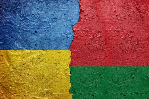 Ukraine and Belarus - Cracked concrete wall painted with a Ukrainian flag on the left and a Belarusian flag on the right