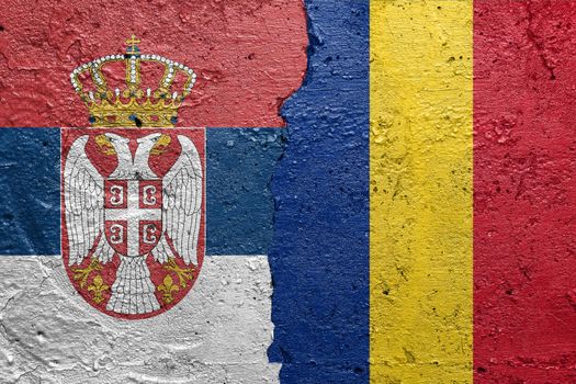 Serbia and Romania flags  - Cracked concrete wall painted with a Serbian flag on the left and a Romanian flag on the right