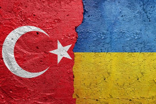 Turkey and Ukraine - Cracked concrete wall painted with a Turkish flag on the left and a Ukrainian flag on the right