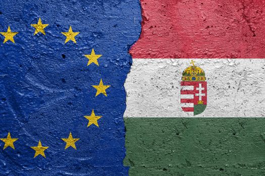 European Union and Hungary flags  - Cracked concrete wall painted with a EU flag on the left and a Hungarian flag on the right