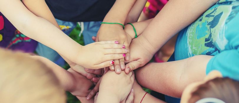 Children's hands together, street games. Selective focus. Kids.