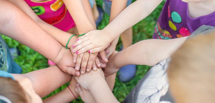 Children's hands together, street games. Selective focus. Kids.