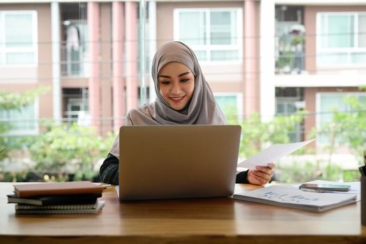 Portrait asian muslim woman manager working with laptop computer for business financial concept